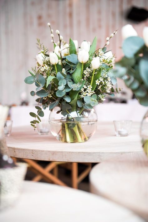 Wedding reception table is decorated with botanical bloom centre pieces of eucalyptus, white wax flowers and tulips. Acrylic Wedding Arch, Tulip Centerpieces Wedding, Tulpen Arrangements, Jessica Grace, Tulip Centerpiece, Tulip Decor, Tulip Wedding, Beautiful Wedding Reception, Wedding Floral Centerpieces