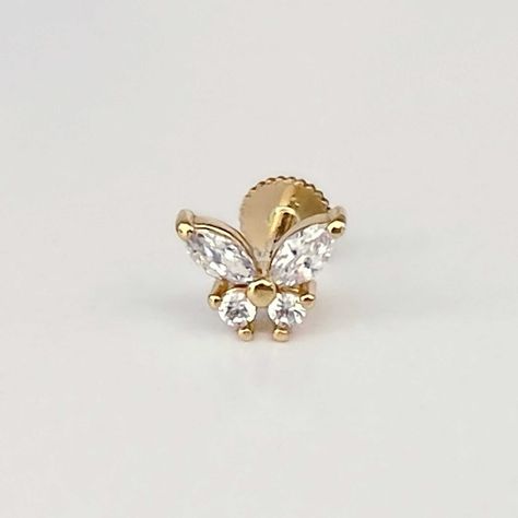 "Our Marquise Butterfly Stud Earring is made with cubic zirconia and 14k solid yellow gold.  It has a flat screw back labret closure to keep it secure and can be worn in your cartilage piercing, helix piercing, conch piercing, or lobe.  This piece looks great in an earring stack mixed with our other labret piercing earrings, or in combination with items from your own collection. Type: Single earring with flat screw back post Post Length : 6.5mm or 8mm Gauge : 18g labret Gemstone : Cubic zirconia Conch Stud, Piercing Conch, Earring Stack, Labret Piercing, Piercing Earrings, Flat Back Earrings, Insect Jewelry, Cartilage Earring, Butterfly Earrings Stud