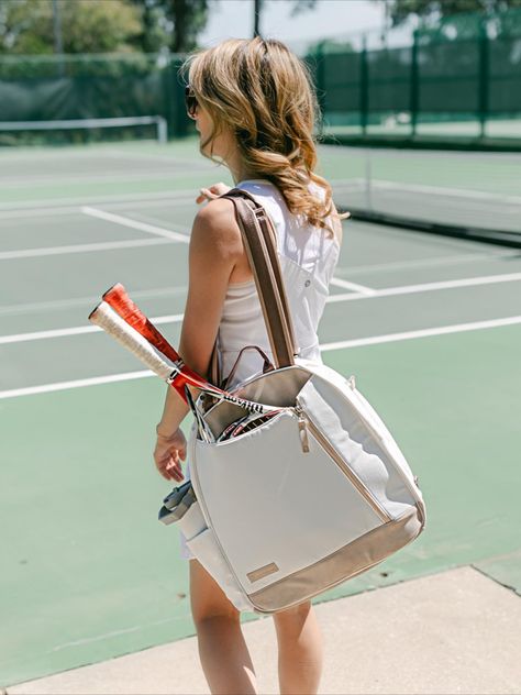 Yup, most of us won’t ever serve or hit forehands like the players on tour. But luckily, we can emulate them in other ways. Tennis pros enhance their natural talents through careful preparation, and so can we. When we show up to a match organized and ready to go, we set ourselves up for success. Choosing the right bag and packing it properly are key. To help us learn how it’s done, we asked pro Palmer Mendelson for some tips from the big leagues. Tennis Tote, Racquet Bag, Tennis Backpack, Tennis Aesthetic, Tennis Tips, Tennis Bags, Tennis Bag, Tennis Racquets, Blush And Grey