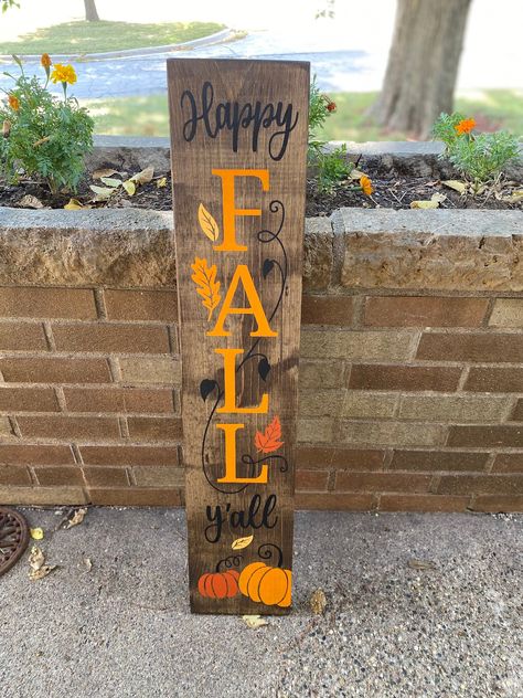 "Hand-painted Wood Sign \"Happy Fall Y'all\" Stained in dark walnut.  Colored vines, pumpkins, and leaves in different fall colors.  Looks so fally and crisp! Love the vertical signs!  Decorate for fall in any part of your house.  These signs fit in anywhere. Display now through Thanksgiving.  Great for Halloween and Thanksgiving.  Front doors and entryways are awesome for these! So popular on patios, patios, decks, steps, etc. measures 36\" tall x 7.5\" wide Everything is stained and painted. Patio Deck Decor, Vertical Signs, Pumpkins And Leaves, Halloween Porch Sign, 2x4 Projects, Fall Wood Crafts, Welcome Signs Front Door, Deck Decor, Decorate For Fall