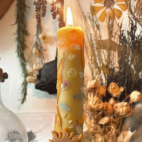 Nikka Phillips ☾ on Instagram: "A candle offering to Apollo 🌞 we’ve had weeks of overcast days here in Los Angeles and I’m really over the May grays…

I crafted a pillar candle in honor of the Greek sun deity. Made with pure golden beeswax and coated in botanicals that correspond to him such as sunflowers and bay laurel. For the final touch, I added a dash of dittany flowers and citrine chips 🌼

if you know of any hymns to Apollo, please drop them in the comments below 🌻" Apollo Candles, Apollo Candle, Sun Deity, Greek Sun, Bay Laurel, Waiting Rooms, Final Touch, Pillar Candle, Pillar Candles