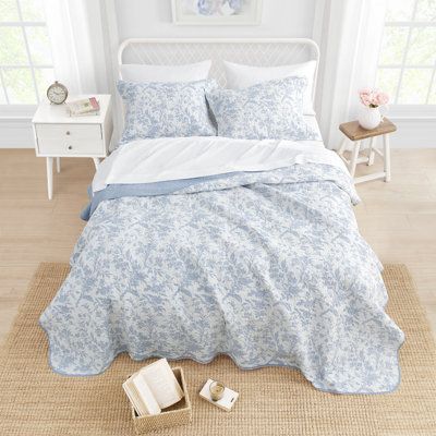 Refresh your bedroom with this lovely floral bedding set, crafted from 100% cotton percale for a soft and breathable feel. The set includes a reversible quilt and matching pillow shams, all featuring a delicate floral pattern that adds a touch of natural beauty to your space. With a 136-thread count, you can expect a cozy and comfortable night's sleep. Plus, it's machine-washable and wrinkle-resistant, making it easy to care for and maintain. Enjoy the inviting atmosphere this bedding set brings Coastal Quilt Sets, Coastal Quilts, Laura Ashley Bedding, King Quilt Sets, Floral Bedding Sets, Laura Ashley Home, Reversible Bedding, Painterly Floral, Cotton Quilt Set