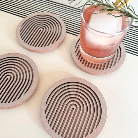 Introducing our set of 4 copper geometric coasters, perfect for protecting your furniture while adding a touch of modern style to any room. Each coaster is lovingly handmade in Milton Keynes, England from sustainable plywood and laser cut to create a unique and striking design.Our coasters are crafted from two pieces of wood, with the top layer featuring a geometric cutout design and the bottom layer left plain black. Each coaster is approximately 11.5cm in diameter and 8mm thick (plus extra for Laser Cut Felt, Beautiful Drinks, Copper Coasters, Laser Cut Coaster, Laser Cut Decor, Geometric Coaster, Modern Coasters, Laser Cut Wood Crafts, Cool Coasters