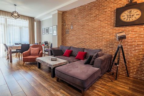 Brick Wall Interior Living Room Modern, Red Brick Interior Living Rooms, Red Brick Wall Living Room, Red Brick Wall Interior, Wall Behind Sofa, Brick Wall Living Room, Brick Apartment, Mom Inspo, Living Room Hardwood Floors