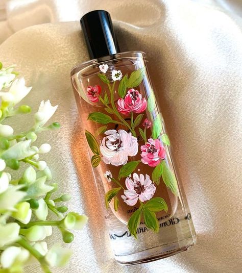 Atlanta Calligrapher & Engraver on Instagram: "Love how this bottle turned out! Florals look good on anything! Bottle painting is really popular on perfumes bottles but it’s not limited to just that! We can paint on the packaging, the box etc Visit our website to learn more about our bottle painting services today! . . . . . #bottlepaintingatlanta #atlantabottlepainter #magicalettering #luxuryevents #brandactivations #floralpainting #purvacreates #calligraphyengraving #bottlepainting" Painting On Perfume Bottles, How To Paint Bottles, Painted Perfume Bottles, Painting On Glass Bottles, Perfume Bottle Painting, Painting On Bottles, Perfume Art Painting, Packaging Painting, Perfume Bottle Decor