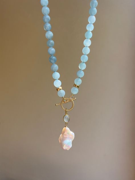 This elegant eye-catching beaded necklace is made of natural aquamarines (AAA quality) and embellished with beautiful baroque pearl pendant settled on an aquamarine charm and gold vermeil toggle clasp. It will become a wonderful gift idea, especially for those who are born in March, as aquamarine is the birthstone for March.  MATERIAL Aquamarine, gold vermeil, freshwater pearl  SPECIFICATIONS Length 46 cm (18 inches) Beads are 8 mm Handmade in Spain Necklace comes in a gift box Worldwide shipmen