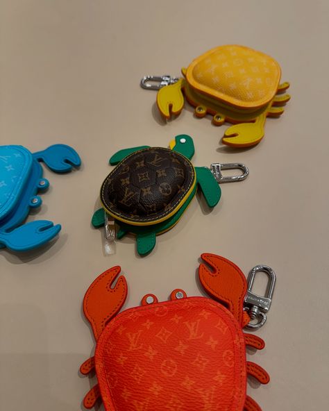 Available in four vibrant colors, this eminently giftable LV Crab Bag Charm brings an uplifting burst of summer color to a favorite bag. A beautifully crafted addition to the growing menagerie of Louis Vuitton animal charms, this playful piece is meticulously assembled from leather with an allover Monogram canvas finish to the body. Introducing the LV Turtle pouch, a fun, functional accessory. Made from Monogram canvas, colorful leather and a silver-tone snap hook, the friendly creature can... Leather Moccasins Diy, Crab Bag, Leather Charms, Animal Bags, Diy Moccasins, Animal Bag, Mini Accessories, Charm Chain, Keychain Design