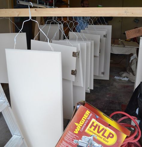 This quick hack makes painting cabinet doors so much quicker. Just grab a metal hanger and let's go! #lifehack Spray Paint Kitchen Cabinets, Spray Paint Cabinets, Painting Cabinet Doors, Paint Cabinet, Kitchen Hanger, Diy Cabinet Doors, Painted Cupboards, Paint Booth, Hanging Cabinet