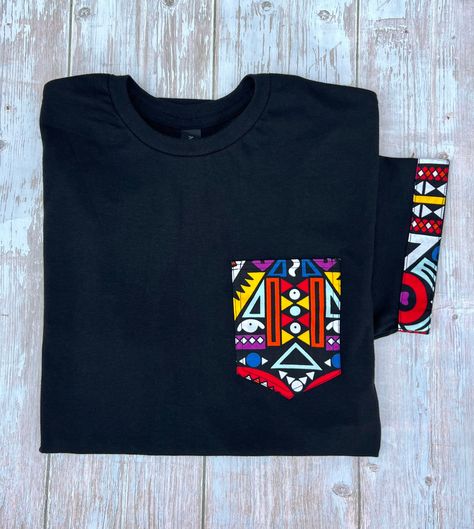 African print pocket Custom shirt African print T-shirt Ankara custom shirt Unisex T-shirt available in size  S-M-L- XL- XXL The pocket and sleeves are made out of Ankara, Kente , Bogolan or African print fabric ( choose any pattern from my shop) Poly blend shirt 60%cotton 40% Polyester  Very soft shirt  You can choose the design contact me if you have any question African Print Tshirt Designs, Ankara Tshirt Designs, African Print Shirt, Mama Africa, Shirts For Teens, African Print Fabric, Custom Shirt, Pocket Shirt, Pocket Tshirt