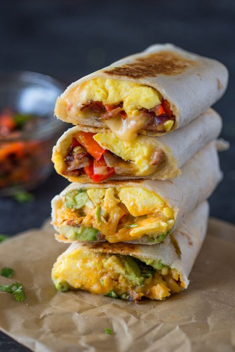 Scrambled eggs, crispy bacon, bell peppers and cheese wrapped in tortillas and toasted until the cheese is melted and gooey and the outside is crispy. These tasty burrito wraps are perfect for brea… Egg Burrito, Cheesy Breakfast, Burrito Wrap, Breakfast Burritos Recipe, Brunch Eggs, Breakfast Wraps, Cheese Wrap, Breakfast Burrito, Burritos Recipe