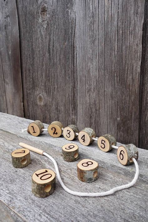 This wooden lacing toy is made from 10 natural tree slices. Each one of them is sanded and covered with a natural/child safe linseed oil.  Size of tree slices: - diameter: 2,5cm - 3 ,5cm - width: 2cm  Because this toy is made from natural branches, each set may differ from one another. And a few cracks or flaws in slices are acceptable, as they occur in the drying process. Math Montessori, Lacing Toy, Montessori Practical Life, Montessori Math, Wooden Numbers, Homemade Toys, Natural Toys, Waldorf Toys, Practical Life