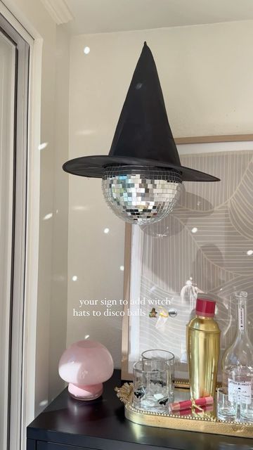 Deborah Trette on Instagram: "let’s make disco witches a thing 💫 so simple and a must for your halloween decor this year! 🖤🖤 #diyhalloween #halloweenideas #halloweendecor #amazonhome #halloween #discoball #hangingwitchhats #spookycute #pinkhalloween" Haunted Disco Party, Halloween Disco Decorations, Disco Ball Halloween Decor, Diy Disco Ball Decor, Halloween Disco Party, Disco Halloween Decor, Disco Ball Halloween, Disco Ghost, Party Moodboard