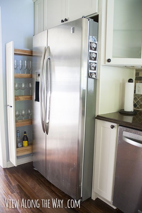 Clever, narrow, sliding out to side of fridge. I probably wouldn't use it for glassware / liquor (I prefer glassware by the sink or bar area & the fridge may emit heat that damages beverages) like the photo but it could be a great spot for other items. Wine Glass Cabinet, Narrow Cabinet Kitchen, Side Of Fridge, Tall Narrow Storage Cabinet, Alcohol Storage, Narrow Storage, Narrow Storage Cabinet, Refrigerator Cabinet, Large Fridge