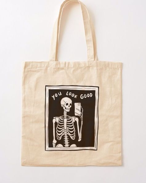 cotton tote bag with illustration of a skeleton taking a mirror selfie. text reads "you look good." Skeleton Mirror Selfie, Black Tote Bag Design Ideas, Black Tote Bag Aesthetic, Tote Bag Design Ideas Aesthetic, Skeleton Mirror, Aesthetic Tote Bag Design, Mirror Selfie Black, Tote Bag Illustration, Black And White Goth