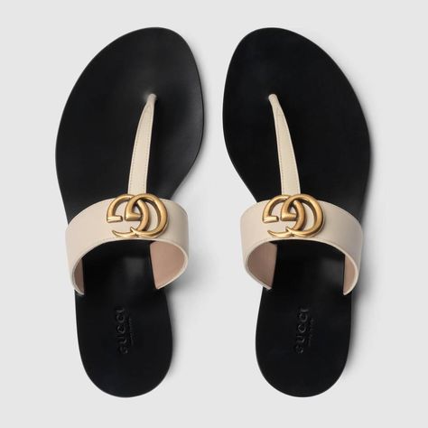 Shop the Leather thong sandal with Double G by Gucci. An emblem of the GG Marmont line, the Double G is an archival play on the original Running G, a belt buckle that first appeared in Gucci collections in the 70s. For Pre-Fall 2018, the antique gold-toned detail defines a pair of flat white leather thongs. Gucci Sandals, Gucci Gifts, Leather Thong Sandals, Gucci Leather, How To Make Shoes, Womens Slides, Sport Sandals, Tory Burch Miller Sandal, Designer Sandals