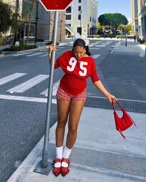 Dive into summer vibes with a vibrant crimson ensemble, Y2K flair, and fresh outfit inspiration. Elevate your look with a stylish graphic tee, sporty detailing, smocked textures, red gingham shorts, tall white socks, statement red flats, and a chic white hair scrunchie. Find your fashion muse @handsomegirly Red And White Sporty Outfit, Scrunchie Socks Outfit, Scrunchy Socks Outfit, Summer Fits Baddie, Gingham Shorts Outfit, Summer Fits Aesthetic, Beach Outfit Casual, Hot Summer Looks, Trendy Summer Fits