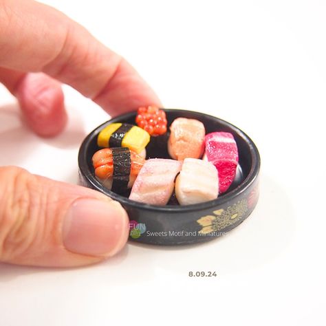 Miniature Polymer Clay Sushi Round Plate (7 Pieces) Delight in this meticulously handcrafted miniature sushi set! Featuring 7 unique sushi pieces, all arranged on a sleek black round tray with a 4.5 cm diameter. Each sushi is securely glued to the tray to prevent damage and ensure long-lasting display. These sushi pieces are skillfully made by hand, without the use of molds, using Modena air-dry waterproof clay. Painted with water-resistant model paints, the vibrant colors remain intact over... Polymer Clay Sushi, Clay Sushi, Miniature Polymer Clay, Sushi Set, Model Paint, Round Tray, Air Dry, Polymer Clay, Tray