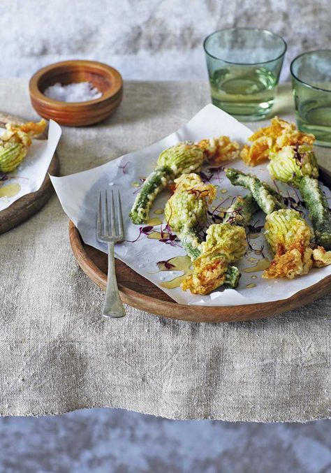 Makes 12. The crispy tempura-style batter on these deep-fried courgette flowers gives way to a creamy cheese filling that's spiked with fresh mint.  Recipe from Round to Ours by Laura Jackson and Alice Levine. Photo by Kristin Perers. (Quadrille). Fried Courgette, Mint Food, Courgette Flowers, Fried Zucchini Flowers, Flower Recipes, Roman Food, Perfect Dinner Party, Mint Recipes, Zucchini Fries