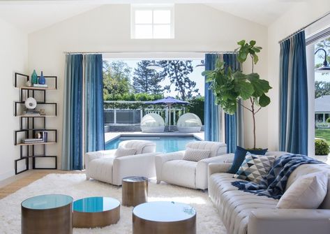 Living Room Pool View, Living Room With Pool View, Living Room White And Blue, Living Room With Pool, White And Blue Living Room, Living Room Pool, Blue Bookshelves, Adam Hunter, Brown And Blue Living Room