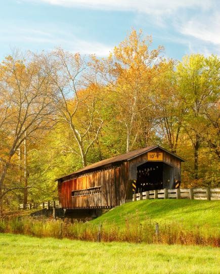 Benetka Road Covered Bridge, built about 1900 and renovated in 1985, spans the Ashtabula River and is one of 17 historic and reconstructed bridges in northeast Ohio's Ashtabula County. In the fall, the Ashtabula County Covered Bridge Festival features tours of the bridges plus country music, a parade and other entertainment. See our story for more Midwest fall color getaways. Ashtabula County, Old Bridges, Midwest Living, Wooden Bridge, Covered Bridge, Autumn Drives, Country Side, Autumn Harvest, Beautiful Autumn