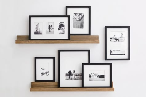 Picture Frames On Small Wall, Picture Frames Decoration Ideas, Asymmetrical Tv Wall Decor, Simple Black And White Interior Design, Small Living Room Photo Wall Ideas, Photo Frame Shelf, Floating Shelf Photo Display, Rustic Picture Frames On The Wall, Staggered Picture Ledges