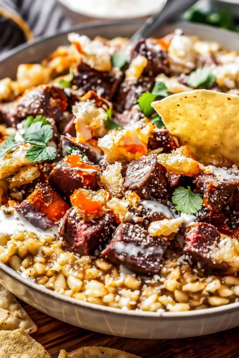 This Carne Asada Street Corn Dip is made with tender corn kernels cooked in a deeply savory, bone marrow-based broth and topped with juicy, steak. Perfect for Cinco de Mayo. Mexican Corn Dip, Street Corn Dip, Mexican Street Corn Dip, Corn Dip Recipes, Mexican Pork, Mexican Appetizers, Corn Dip, Street Corn, Mexican Food Recipes Easy