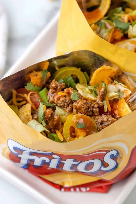 Walking Tacos - Everyone loves tacos in a bag! This fun family party snack is easy to make and delicious. Add your favorite taco toppings in your bag of Fritos and seasoned beef. Tacos In A Bag, Frito Recipe, Walking Tacos Recipe, Tacos Easy, Books Of 2023, Baked Chicken Wings Oven, Taco Toppings, Simply Stacie, Walking Tacos