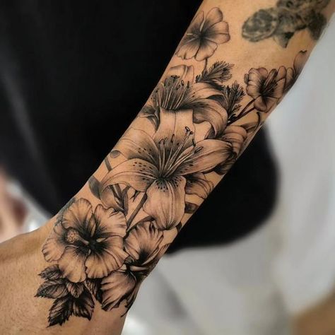 90 Awesome Lily Tattoo Designs with Meaning | Art and Design Black Lily Tattoo Cover Up, Hibiscus And Lily Flower Tattoo, Lilly Vine Tattoo, Hibiscus And Lily Tattoo, Mens Lily Tattoo, Lily Sleeve Tattoos For Women, Lilly Tattoo For Men, Lilly Tattoo Men, Black And White Lily Tattoo