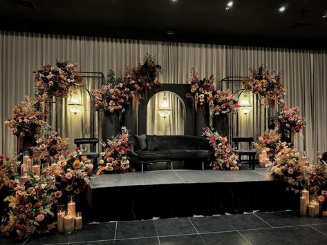 Layered floral tones and rich textures set the stage, while matching colored sand candles added the perfect finishing touch. Styling, decor, flowers and set up by @museweddingsandevents Candles by @rosewood.candles Reception Decor Ideas Indian, Khaleeji Wedding, Vintage Reception Decorations, Vintage Reception, Sangeet Decor, Wedding Stages, Indian Reception, Red Wedding Decorations, Wedding Stage Decor