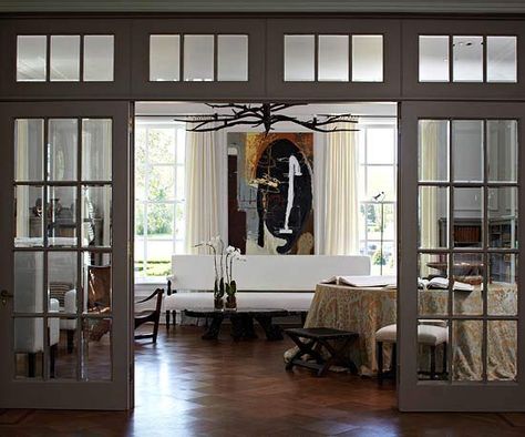 Glass French Doors  Like windows, doors are a key part of any wall's composition. Here, beautiful French doors separate the living room from a large foyer, while still letting light flow freely between rooms. Incorporating a pair of French doors into a living space allows you to add a little old-fashioned charm. Beautiful French Doors, Double Doors Interior, Glass French Doors, Design Salon, Glass Doors Interior, Interior Windows, Door Design Interior, French Doors Interior, The Dining Room