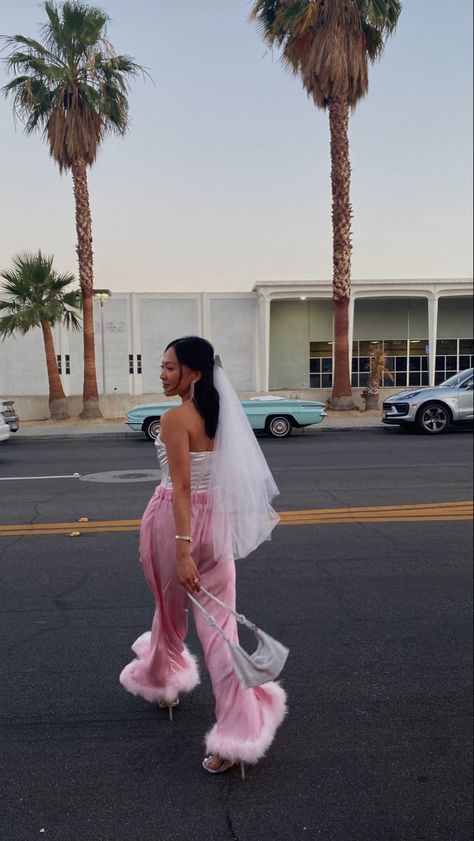 Sunset photo backdrop featuring a bride to be in pink feather trimmed pants and bow veil Barbie Bride Outfit, Barbie Bachelorette Outfit, Black Bride Bachelorette Outfit, Unique Bachelorette Outfits, Barbie Bride Bachelorette Outfit, Bach Outfits For Bride, White Barbie Outfit, Vegas Bachelorette Outfits, Palm Springs Bachelorette Outfits