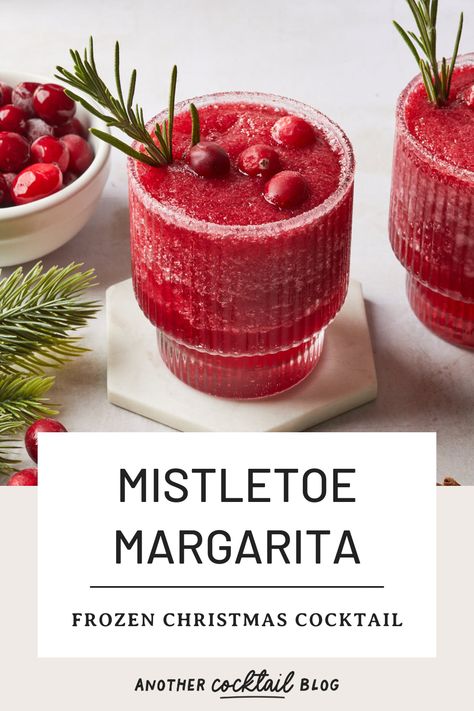 Made with a combination of cranberry and pomegranate, and sweetened with rosemary simple syrup, these frozen mistletoe margaritas are a festive twist on the classic margarita. Garnish with a sugared rim, fresh rosemary and cranberries to create a Christmas margarita worth of your holiday celebrations. Mistletoe And Margaritas Party, Margarita Garnish, Mistletoe Margaritas, Mistletoe Margarita, Cointreau Margarita, Tequila And Lemonade, Christmas Margarita, Frozen Watermelon Margarita, Cranberry Pomegranate