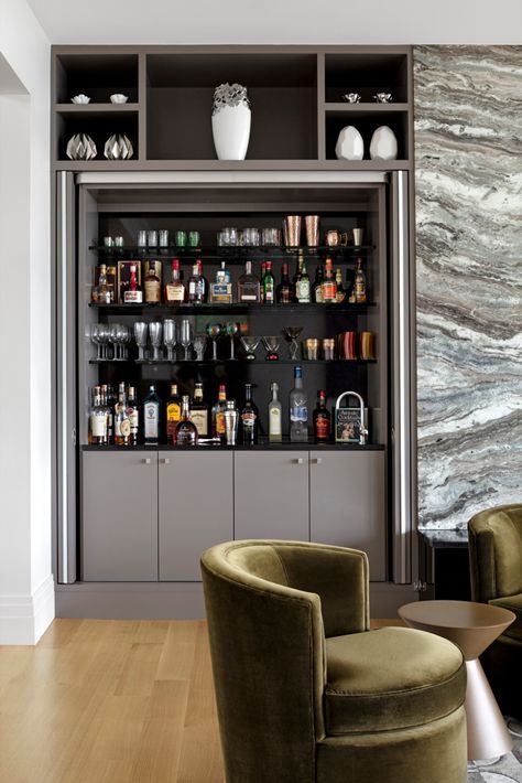 This custom wet bar features built-ins, able to be hidden behind doors. Hidden Bar Cabinet Built Ins, Home Bar Hidden, Hidden Bars At Home, Hidden Bar Cabinets For Home, Hidden Home Bar Ideas, Hidden Bar Unit In Living Room, Hidden Bar In Living Room, Built Ins With Bar, Bedroom With Bar