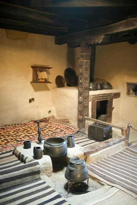 An ancient style kitchen with stone pots on display in a museum in the Hunza Valley, Gilgit-Baltistan, Pakistan. Ancient Home Design, Mud House Kitchen, Cob Kitchen, Ancient Kitchen, Ancient Homes, Kitchen With Stone, Mud Houses, Hunza Valley, Ancient Houses