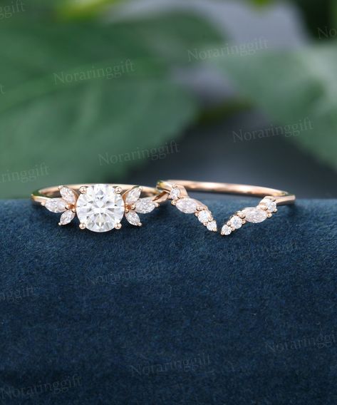 "Moissanite engagement ring set vintage Unique rose gold engagement set Marquise diamond Cluster wedding set Opening Bridal set Annual ring -----Ring Information----- Engagement ring +Center stone: 6.5mm Moissanite +Cut type: Round shaped +Side Stone:  Natural Diamonds or Moissanite Approx weight: 0.3ctw Wedding band  +Stones: Diamonds or Moissanite Approx weight: 0.2ctw Metal : Solid 14k/18k yellow gold white gold or rose gold, other metal or gemstones, please contact me! Click on the \"Pin It\ Dainty Bridal Sets Rings, Engagement Rings Cheap Budget, Nesting Engagement Ring Set, Moissanite Rose Gold Engagement Ring, Nesting Engagement Ring, Leaf Wedding Band With Engagement Ring, Unique Wedding Rings Engagement Bridal Sets, Engagement Rings And Wedding Bands Set, Bridal Sets Rings