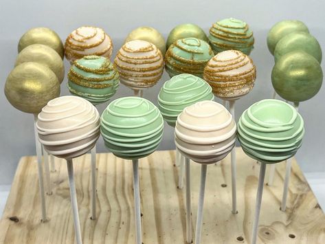 Green And Gold Gender Reveal Party, Sage Green And Gold Cake Pops, Princess Tiana Desserts, Light Green Cake Pops, Sage Green And White Cake Pops, Sage Green And Gold Dessert Table, Green Candy Table Ideas, Forest Green Cupcakes, Forest Green Dessert Table