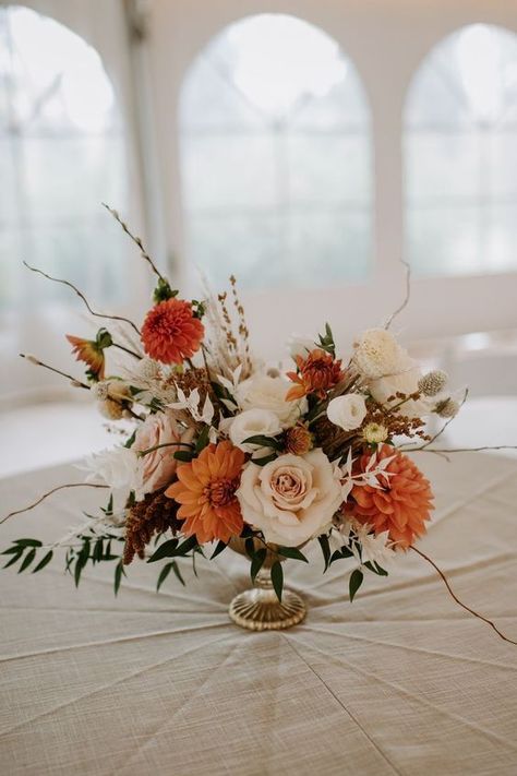 Centerpiece Inspiration: 1/2 tables with small/medium centerpieces; 1/2 tables with 3-5 small bud vases & candles Boho Fall Wedding Florals, Floral Arrangements For Fall Wedding, Rust Orange Floral Arrangement, Terracotta Flowers Wedding Table, Floral Arrangements Fall Wedding, Wedding Florals Terracotta, Wedding Flower Arrangements Bouquets, Fall Boho Wedding Flowers Centerpieces, Autumnal Wedding Flowers Table