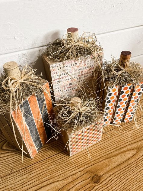 Easy DIY Pumpkin Blocks Using Scrapbook Paper Wood And Scrapbook Paper Crafts, Thanksgiving 2x4 Crafts Diy, How To Put Scrapbook Paper On Wood, 4 By 4 Wood Crafts, Fall Outdoor Wood Decor, Fall Scrapbook Paper Crafts, Fall Crafts Diy For The Home Front Porch, Pumpkin Signs Diy, Jenga Pumpkins