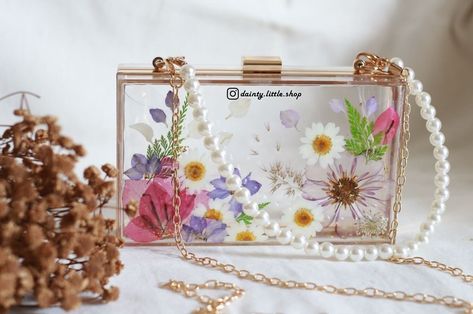 New drops: Beautiful floral resin clutch 👜 Elevate your style quotient in a blink with these exquisite floral resin clutches. Available in all these designs, check them out now! DM to order or enquire for prices! 💌 #resinclutch #resinclutches #resinclutchbag #resinpurse #resinbag Resin Clutch, Resin Bag, Floral Resin, Elevate Your Style, Resin Crafts, Bag Making, Clutches, Your Style, Clutch Bag