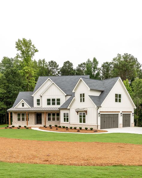 Welcome to the heart of charm! 🌟 Step into this delightful white home, where the gentle hue of brick accents, lush landscaping, and exposed wooden details create a story of timeless warmth. The rich-toned garage adds a touch of cozy sophistication, making every corner picture-perfect!   Builder @restorebuildanddesign   Design @hawkinsandgraydesign   Photo @lyndseymariephotography   Cabinetry @luxecabinetryanddesign    Décor @wilsonhomedecor White And Wooden House Exterior, Two Story White Brick House, White Farmhouse With Brick, White And Stone House Exterior, Farmhouse With Brick, Two Tone House Exterior, Grey Brick House Exterior, White Siding House, White Siding Exterior