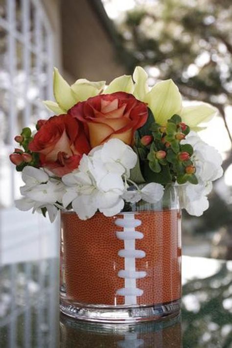 football centerpieces for tables | We really love this clear vase football centerpiece and the lovely ... Football Party Centerpieces, Football Centerpiece, Football Centerpieces, Banquet Centerpieces, Grooms Table, Football Banquet, Football Wedding, Football Baby Shower, Super Bowl Football