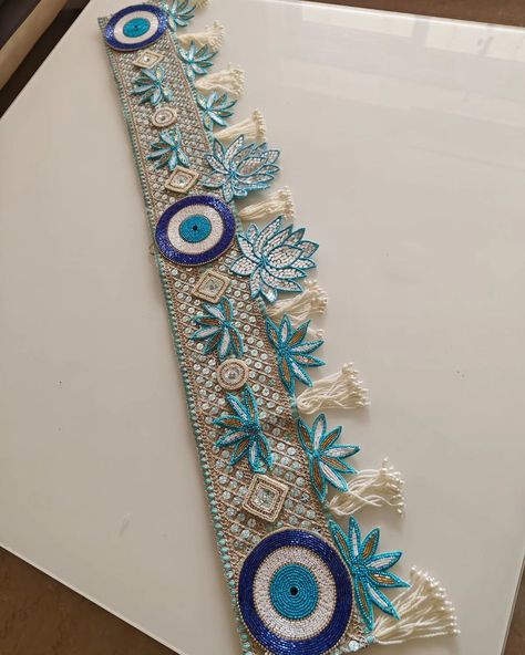 Toran in blue with evil eye Size 40" Mirror Work Toran Design, Evil Eye Toran Design, Evil Eye Bandarwal, Bandarwal Designs Handmade, Diy Bandanwar, Handmade Toran Ideas, Bandanwar Design, Bandarwal Designs, Toran Designs Doors Handmade