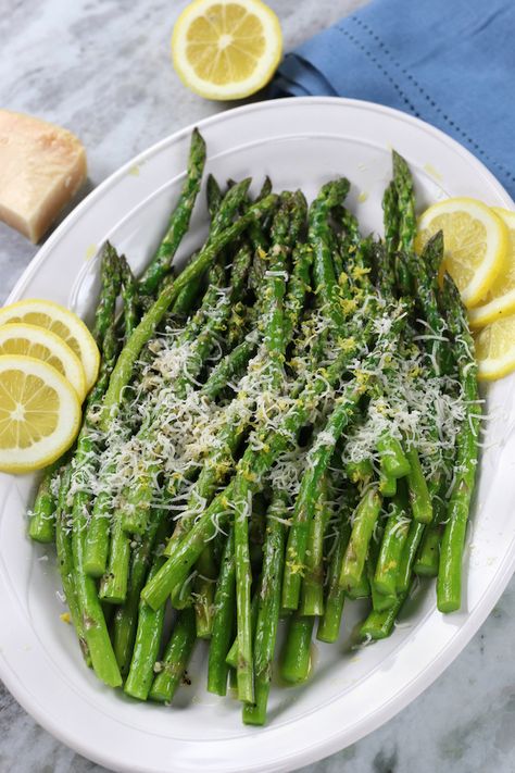 Perfectly tender and yet slightly crisp Roasted Asparagus with garlic, lemon and Parmigiano Reggiano (aka authentic parmesan) is an amazingly delicious side dish. Within the recipe post are tips in choosing the right asparagus, how to store and roasting times. #RoastedAsparagus #RoastedAsparagusOven #SheetPanRoastedAsparagus #HowLongToBakeAsparagusInOven #RoastedAsparagusParmesan #GarlicAsparagusRecipe Roasted Asparagus Parmesan, Grilled Shrimp Kabobs, Marinated Grilled Shrimp, Baby Spinach Recipes, Easter Cocktail, Shrimp Kabob Recipes, After Dinner Cocktails, Oven Roasted Asparagus, Parmesan Asparagus