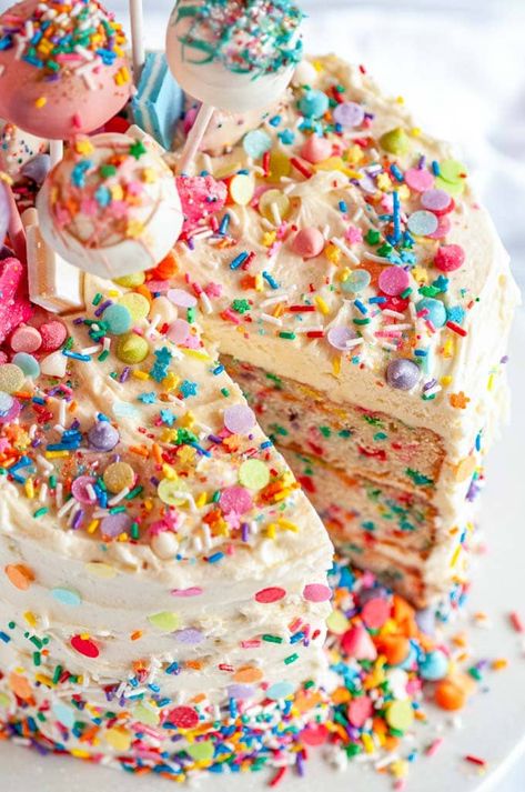 Birthday Surprise Confetti Cake - The ultimate festive birthday cake with a sprinkle explosion surprise inside! Made with a vanilla cake layer base and iced with cream cheese buttercream frosting. From aberdeenskitchen.com #birthday #surprise #confetti #cake #explosion #vanilla #sprinkles #funfetti #dessert #cakepops #buttercream #creamcheese #frosting Sprinkle Inside Cake, Birthday Cake With Sprinkles Inside, Funfetti Cake Frosting, Funfetti Cake With Chocolate Frosting, Sprinkle Cake Decoration, Pink Confetti Cake, Funfetti Cake Decoration, Sprinkle Birthday Cake, Confetti Cake Recipes