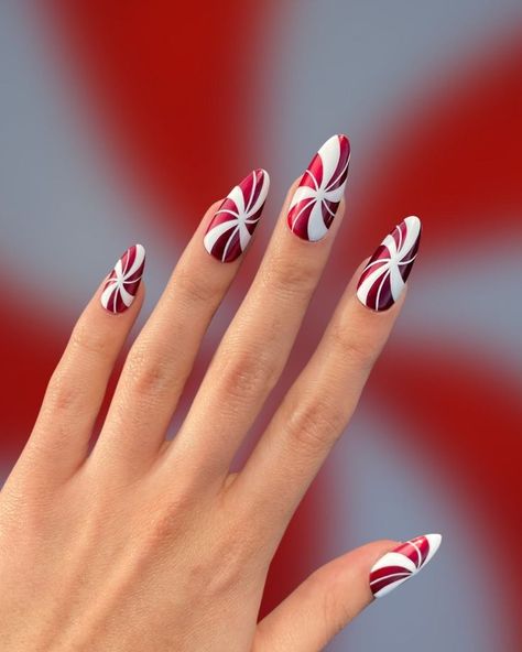 70 Simple Christmas Nail Designs that are cute enough to cause a sugar rush - Hike n Dip Christmas Nail Art Almond Shape, Gingerbread Nail Art Designs, Green Peppermint Nails, Santa Nail Art Christmas, Red And White Candy Cane Nails, Candy Cane Swirl Nails, Peppermint Candy Nails, Christmas Peppermint Nails, Peppermint Nails Design