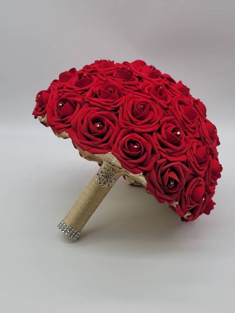 Each bouquet is handmade to order using real touch roses. A rhinestone is placed in the center of every rose. Handle is made up of your choice of satin ribbon and handle accessories: Brooch: Silver, Gold, Or Rose Gold Bling wrap: Silver, Gold, Rose Gold, No accessories Bouquets are available in 4 sizes: 6 inch 8 inch 10 inch-Pictured in listing 12 inch Matching Boutonnieres and corsages available in listing below...Or see store for all styles of boutonnieres and corsages you can customize to you Red Rose Bridal Bouquet, Gold Wedding Bouquets, Ivory Bridal Bouquet, Red Bridal Bouquet, Ivory Bouquet Wedding, Toss Bouquet, Gold Bouquet, Bridal Brooch Bouquet, Bridesmaids Bouquet