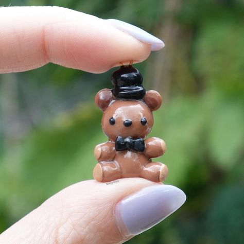 Little Freddy Fazbear 🐻 These are up on my shop! ✨ - ✨ - ✨ - ✨ - #polymerclay #axolotl #etsy #smallbusiness #clayart #clay #sculpture #gamingart #girlartist #kawaii #chibi #keychain #pokemon #bugs #rdr2 #fnaf Minecraft Clay Charms, Axolotl Clay, Notion Green, Clay Axolotl, Chibi Keychain, Clay Chibi, Clay Pokemon, Ceramic Charms, Clay Keychain