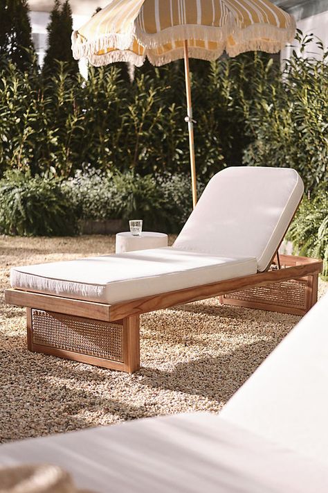 Coated in a UV- and water-resistant fabric, this lounge chaise was made for dreamy warm-weather days. A soft cushioned seat rests atop a natural teak wood base, finished with intricate rattan-esque paneling. For ordering assistance and more, please contact us For aesthetic advice and tips to help decorate your space, enjoy our complimentary home styling services | Merit Chaise Lounge by Anthropologie in Beige Lounge Chaise, Teak Chaise Lounge, Pool Lounge Chairs, Pool Chairs, Pool Lounger, Useful Ideas, Natural Teak Wood, Deck Designs Backyard, Outdoor Lounge Chair