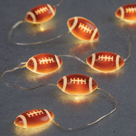 Purchase the 6ft. Football Crafting Lights by Celebrate It™ at Michaels. Perfect to use for crafting a DIY wreath, garland or adding to a centerpiece, these football crafting lights will be a crafting hit! Not only will it illuminate your craft, this set of crafting lights will get you ready for football season. Perfect to use for crafting a DIY wreath, garland or adding to a centerpiece, these football crafting lights will be a crafting hit! Not only will it illuminate your craft, this set of crafting lights will get you ready for football season. Details: Brown football icons 6 ft. (1.8 m) lighted length 7 ft. (2.1 m) total length Requires 2 x AA batteries (not included) For indoor use only | 6Ft Football Crafting Lights by Celebrate It™ | Michaels® Chili Contest, Football Lights, Battery Powered Fairy Lights, Football Lover Gifts, String Lights Party, String Ball Lights, Battery String Lights, Light Decoration, Gifts For Football Fans