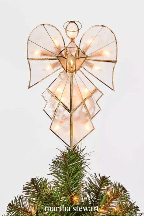 An angel earns her wings as the topper of any Christmas tree. This modern topper—with 16 white lights—adds even more excitement to your holiday display. It's composed of clear capiz shells framed inside a gold metal trim for pretty ornamental flair. #christmas #holidayideas #christmasideas #wintertodo #marthastewart Light Up Angel Tree Topper, Modern Angel Tree Topper, Glass Angel Tree Topper, Angel On Christmas Tree, Diy Christmas Tree Topper Angel, Cross Tree Topper, Christmas Tree Toppers Angel, Stained Glass Angel Tree Topper, Diy Angel Topper For Christmas Tree